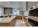 Well-lit kitchen showcases wood cabinetry, stone countertops, and stainless steel appliances at 10313 Orkiney Dr, Las Vegas, NV 89144