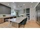 Well-lit kitchen featuring a large island with seating, marble countertops, and modern appliances at 10313 Orkiney Dr, Las Vegas, NV 89144