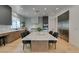 Contemporary eat-in kitchen featuring marble countertops, stainless steel appliances, and custom cabinets with dining area at 10313 Orkiney Dr, Las Vegas, NV 89144