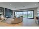 Bright and open living room with modern fireplace, sleek shelving, and sliding glass doors showcasing the outdoor view at 10313 Orkiney Dr, Las Vegas, NV 89144