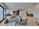 Living room with wood floors open to the kitchen and dining room with modern decor at 10313 Orkiney Dr, Las Vegas, NV 89144