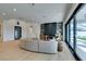 Open-concept living room with vaulted ceiling, modern fireplace, and sliding glass doors that leads outside at 10313 Orkiney Dr, Las Vegas, NV 89144