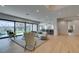 Bright living room includes hardwood floors, a curved sofa, and a view of the pool at 10313 Orkiney Dr, Las Vegas, NV 89144