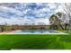 Beautiful in-ground pool surrounded by green artificial turf at 10313 Orkiney Dr, Las Vegas, NV 89144