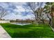 Beautiful in-ground pool surrounded by green artificial turf and landscaping at 10313 Orkiney Dr, Las Vegas, NV 89144