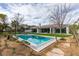 View of the in-ground pool and green space from ground level at 10313 Orkiney Dr, Las Vegas, NV 89144