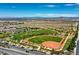 Expansive aerial view of community park including a baseball field, green space, trees, and walking paths at 10421 Mount Washington Ave, Las Vegas, NV 89166