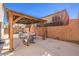 This backyard features a shaded pergola over a patio and sitting area with a block wall and hardscape at 10421 Mount Washington Ave, Las Vegas, NV 89166