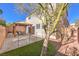 The backyard features a pergola-covered patio, a pet-friendly fenced area, and lush landscaping at 10421 Mount Washington Ave, Las Vegas, NV 89166