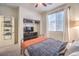 Bright bedroom featuring plush carpet, closet, and large window at 10421 Mount Washington Ave, Las Vegas, NV 89166