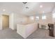 Bright hallway featuring neutral paint, plush carpeting, and multiple windows for ample natural light at 10421 Mount Washington Ave, Las Vegas, NV 89166