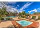 Relaxing hot tub with nearby pool and lounge chairs for resident enjoyment at 10421 Mount Washington Ave, Las Vegas, NV 89166