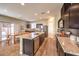 Open kitchen with stainless steel appliances, a central island, granite countertops and adjacent dining area at 10421 Mount Washington Ave, Las Vegas, NV 89166