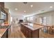 Open kitchen with stainless steel appliances, granite countertops, a central island, and hardwood floors at 10421 Mount Washington Ave, Las Vegas, NV 89166