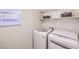 Neat laundry room with modern appliances, a window for natural light, and a clean, bright atmosphere at 10421 Mount Washington Ave, Las Vegas, NV 89166