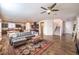 Spacious living room flows into the kitchen and entryway and features a gray sofa and staircase at 10421 Mount Washington Ave, Las Vegas, NV 89166