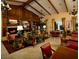 Inviting living room with a fireplace, wood paneling, beamed ceilings, and elegant furnishings at 10421 Mount Washington Ave, Las Vegas, NV 89166