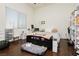 Bedroom with laminate flooring, a large window, and neutral decor, offering a cozy and inviting space at 1092 Via Corto St, Henderson, NV 89011