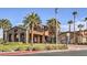 Exterior view of the clubhouse featuring a stone facade, arched entryways, and manicured landscaping at 1092 Via Corto St, Henderson, NV 89011