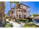 Low angle view of a multi-story condo building with beige stucco and lush landscaping at 1092 Via Corto St, Henderson, NV 89011