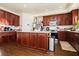 Kitchen featuring dark wood cabinets, stainless steel appliances, and a center island at 1092 Via Corto St, Henderson, NV 89011