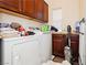 Laundry room features a washing machine, dryer, storage cabinets and a utility sink at 1092 Via Corto St, Henderson, NV 89011