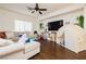 Bright living room featuring neutral walls, a ceiling fan, and hardwood floors at 1092 Via Corto St, Henderson, NV 89011