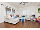 Bright living room featuring neutral walls, a ceiling fan, and hardwood floors at 1092 Via Corto St, Henderson, NV 89011