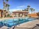 Resort style swimming pool features clear blue water, palm trees, and a shaded pavilion at 1092 Via Corto St, Henderson, NV 89011