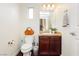 Charming powder room with vanity, mirror, and toilet, ideal for guests at 1092 Via Corto St, Henderson, NV 89011