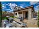 Exterior view of a backyard with covered patio, outdoor seating, and artificial turf at 11023 Bellatrix Ct, Las Vegas, NV 89135