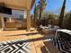 Outdoor kitchen with a built-in barbecue, a seating area with fire pit, and a paved patio with an outdoor dining table at 11023 Bellatrix Ct, Las Vegas, NV 89135