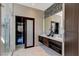 Modern bathroom with double vanity, large mirror, and glass enclosed shower at 11023 Bellatrix Ct, Las Vegas, NV 89135