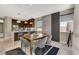 Open-concept dining area adjacent to a modern kitchen with stainless steel appliances and island seating at 11023 Bellatrix Ct, Las Vegas, NV 89135