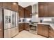 A well-equipped kitchen with stainless steel appliances, white countertops, and sleek, dark wood cabinetry at 11023 Bellatrix Ct, Las Vegas, NV 89135