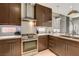 Stylish kitchen with stainless steel appliances, white subway tile backsplash, and dark wood cabinetry at 11023 Bellatrix Ct, Las Vegas, NV 89135