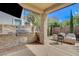 Outdoor kitchen with built-in grill, pizza oven, and stone surround at 11023 Bellatrix Ct, Las Vegas, NV 89135