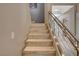 Staircase with light wood treads and a modern metal railing at 11023 Bellatrix Ct, Las Vegas, NV 89135