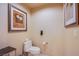 Toilet room with wallpaper, matching artwork, and a black side table at 135 E Harmon Ave # 2821, Las Vegas, NV 89109