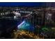 Panoramic city view with an illuminated Topgolf and vibrant lights at night at 135 E Harmon Ave # 2821, Las Vegas, NV 89109