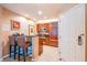 Modern kitchen with bar stool seating and stainless steel appliances next to the entry door at 135 E Harmon Ave # 2821, Las Vegas, NV 89109