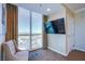 Bright living room featuring a large window with stunning city views and a wall-mounted television at 135 E Harmon Ave # 2821, Las Vegas, NV 89109