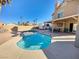 A refreshing backyard pool with desert landscaping and a covered patio for outdoor entertaining at 1508 Splinter Rock Way, North Las Vegas, NV 89031