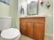 Stylish half bathroom featuring a wooden vanity with a light countertop and a modern toilet at 1508 Splinter Rock Way, North Las Vegas, NV 89031