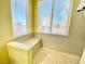 Bright bathroom featuring tiled walls and a shower bench seat under a window at 1508 Splinter Rock Way, North Las Vegas, NV 89031