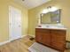 Bathroom with wood-look floors, a light fixture, and a vanity with storage at 1508 Splinter Rock Way, North Las Vegas, NV 89031