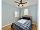 Blue bedroom with wood floors, light blue walls, and a plaid-covered bed at 1508 Splinter Rock Way, North Las Vegas, NV 89031