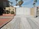 Gated driveway with white gate, RV parking, and desert landscaping at 1508 Splinter Rock Way, North Las Vegas, NV 89031