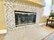 Close-up of fireplace with tile surround and glass doors adding warmth and elegance to the living space at 1508 Splinter Rock Way, North Las Vegas, NV 89031