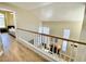 Open hallway overlooking the living room, with wood floors, tall ceilings, and natural light at 1508 Splinter Rock Way, North Las Vegas, NV 89031